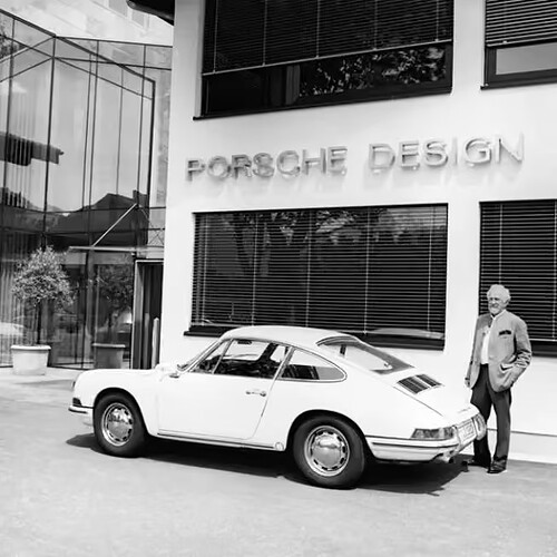 prof-fa-porsche-standing-next-to-white-porsche-911-porsche-design-studio-in-back